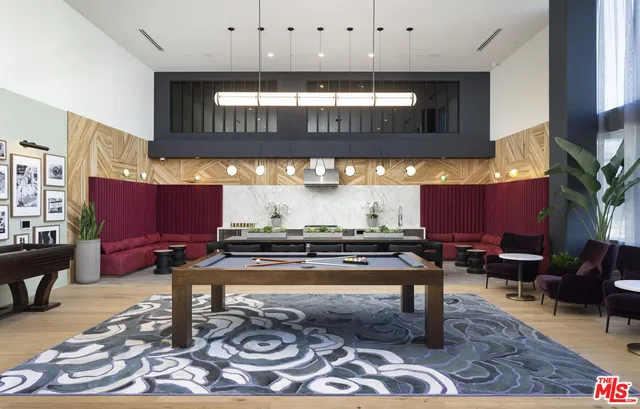 a living room with furniture a rug and kitchen view