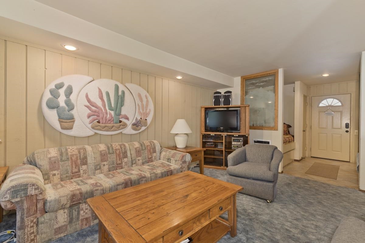244 Lakeview Boulevard, Unit 149 Mammoth Lakes, CA 93546 - Photo 1 of 29 Living room featuring recessed lighting, carpet flooring, and wood walls