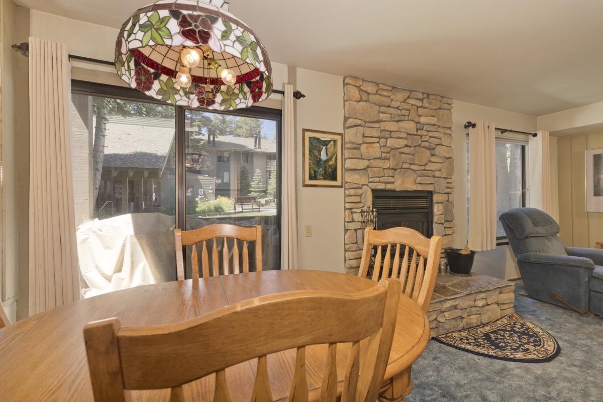 244 Lakeview Boulevard, Unit 149 Mammoth Lakes, CA 93546 - Photo 16 of 29 Carpeted dining room with a fireplace