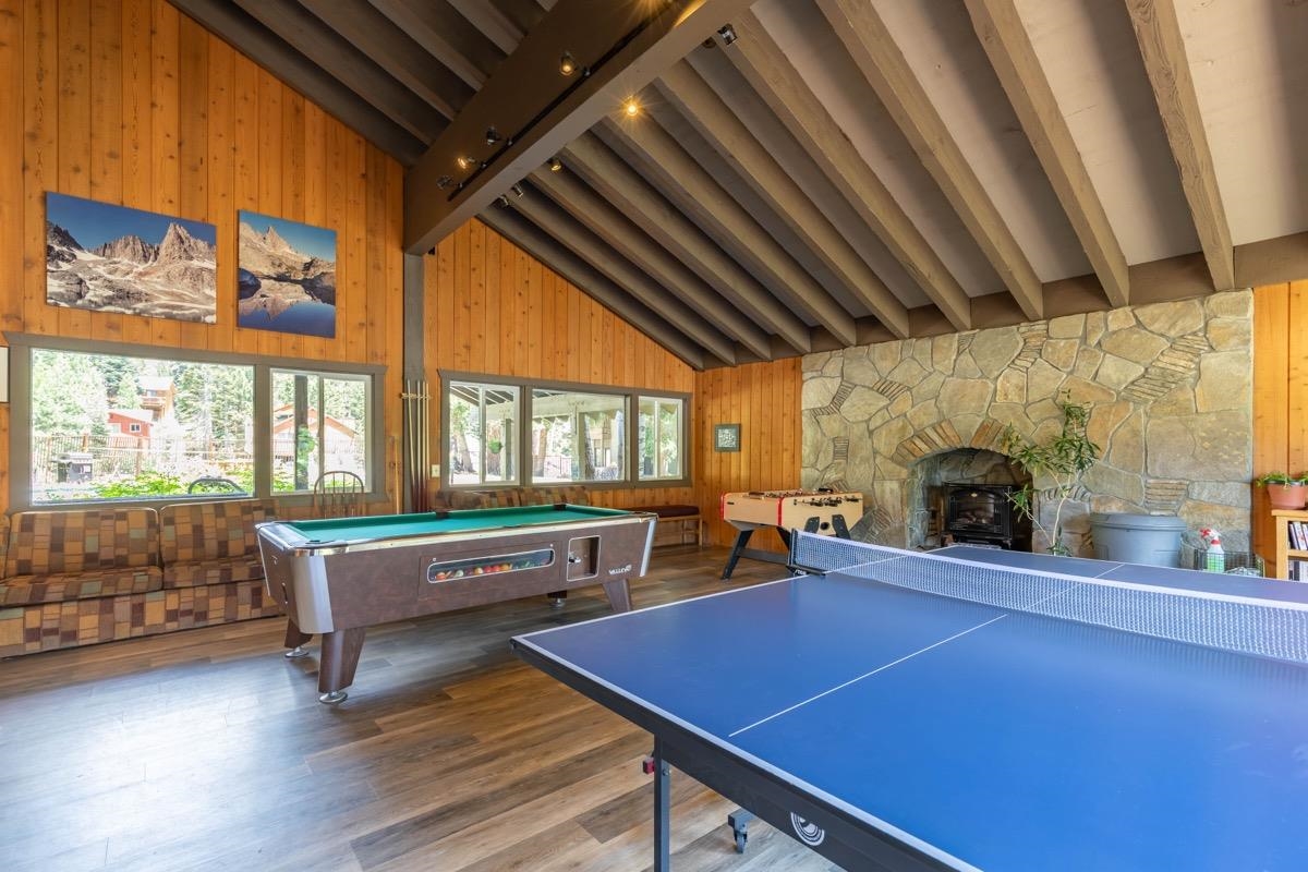 244 Lakeview Boulevard, Unit 149 Mammoth Lakes, CA 93546 - Photo 23 of 29 Game room with wood walls, beamed ceiling, billiards, dark wood finished floors, and high vaulted ceiling