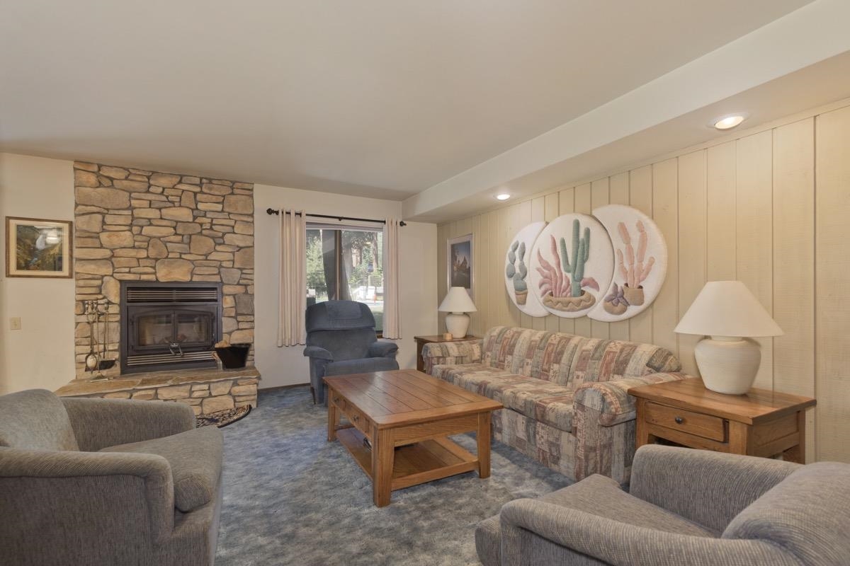 244 Lakeview Boulevard, Unit 149 Mammoth Lakes, CA 93546 - Photo 3 of 29 Carpeted living area featuring a stone fireplace