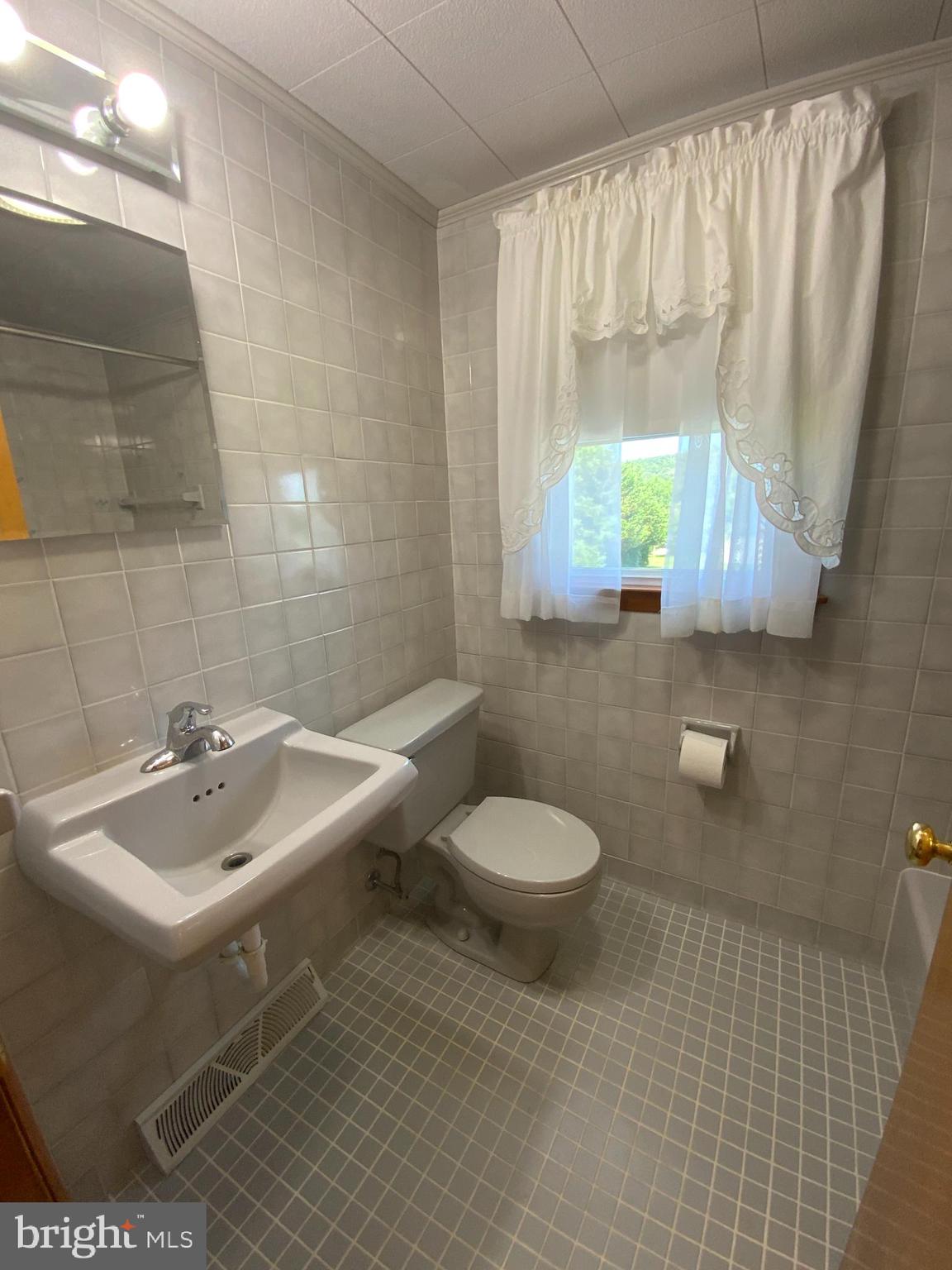 25476 Military Road Cascade, MD 21719 - Photo 23 of 30 a bathroom with a sink toilet and mirror