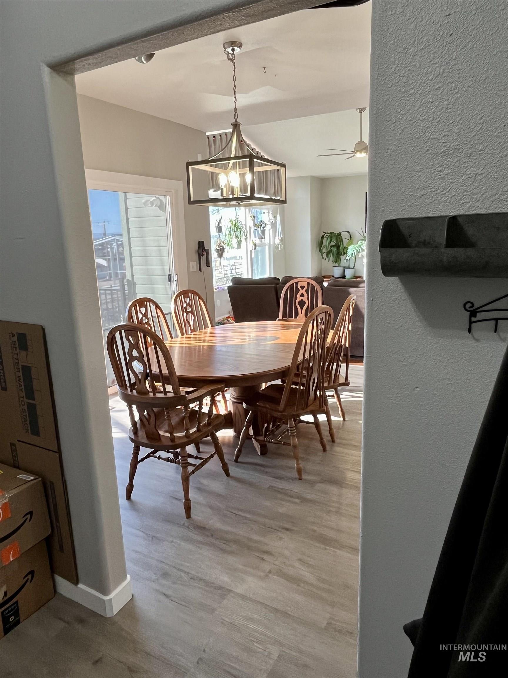 23919 Tyler Lane Middleton, ID 83644 - Photo 25 of 48 Dining area with light wood-type flooring, ceiling fan, a chandelier, and a textured wall