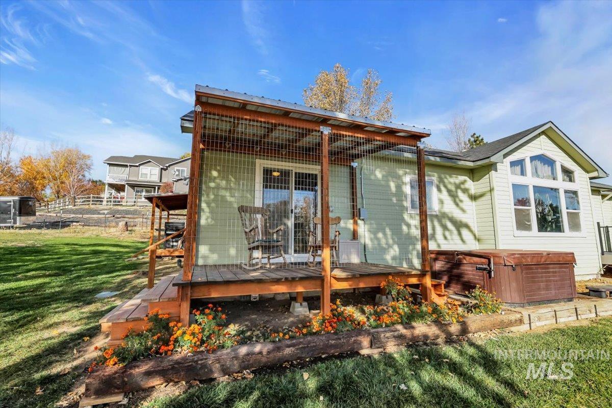 23919 Tyler Lane Middleton, ID 83644 - Photo 5 of 48 Back of house featuring a deck and a hot tub