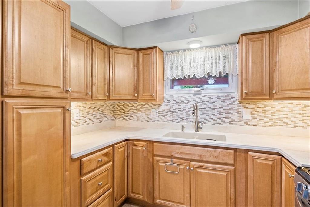 328 Wallrose Heights Road Baden, PA 15005 - Photo 6 of 23 a kitchen with stainless steel appliances granite countertop white cabinets and a sink