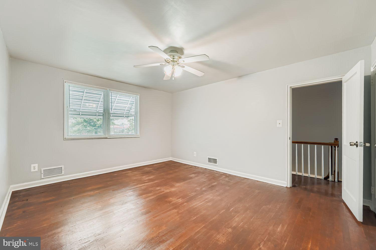 5466 Addington Road Baltimore, MD 21207 - Photo 15 of 31 Bright and airy room with hardwood floors.
