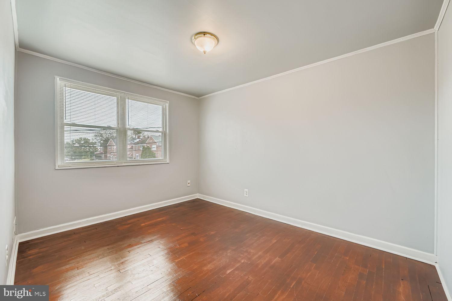 5466 Addington Road Baltimore, MD 21207 - Photo 20 of 31 Bright and airy room with hardwood floors.