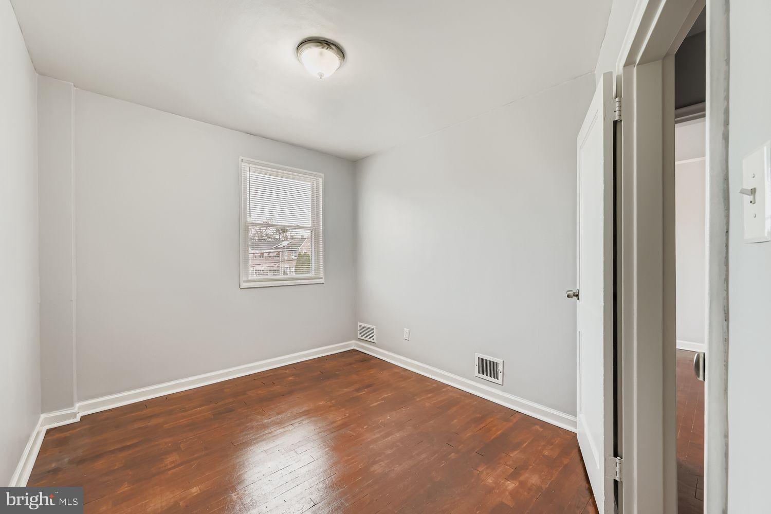 5466 Addington Road Baltimore, MD 21207 - Photo 22 of 31 Bright and airy room with hardwood floors.
