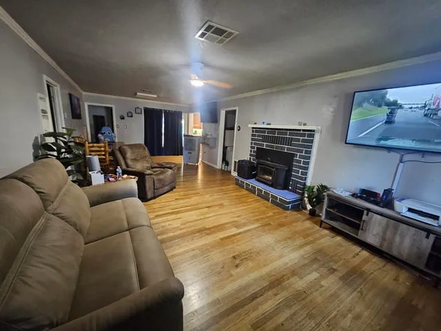 a living room with furniture a flat screen tv and a fireplace