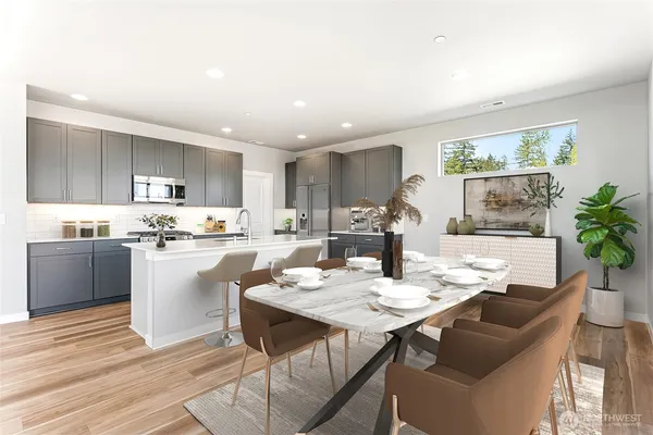 a kitchen with a dining table chairs and refrigerator