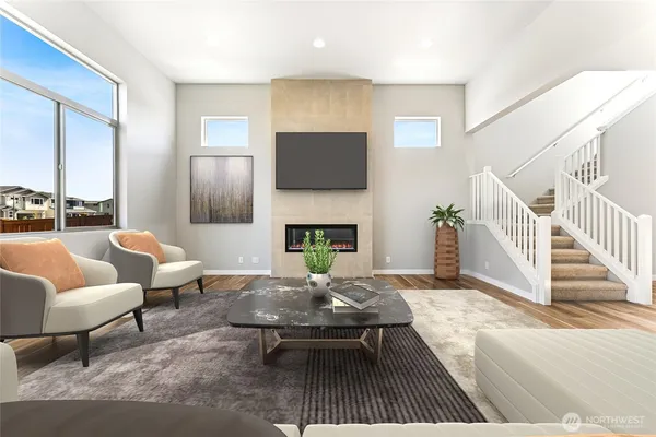 a living room with furniture a rug a fireplace and a flat screen tv