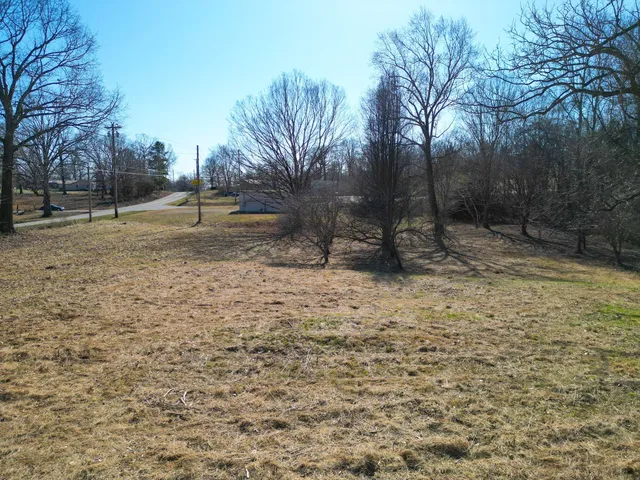 a backyard of a house with large trees