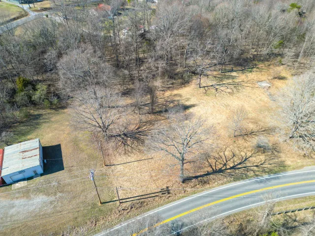 a aerial view of a house with a yard and wooden fence