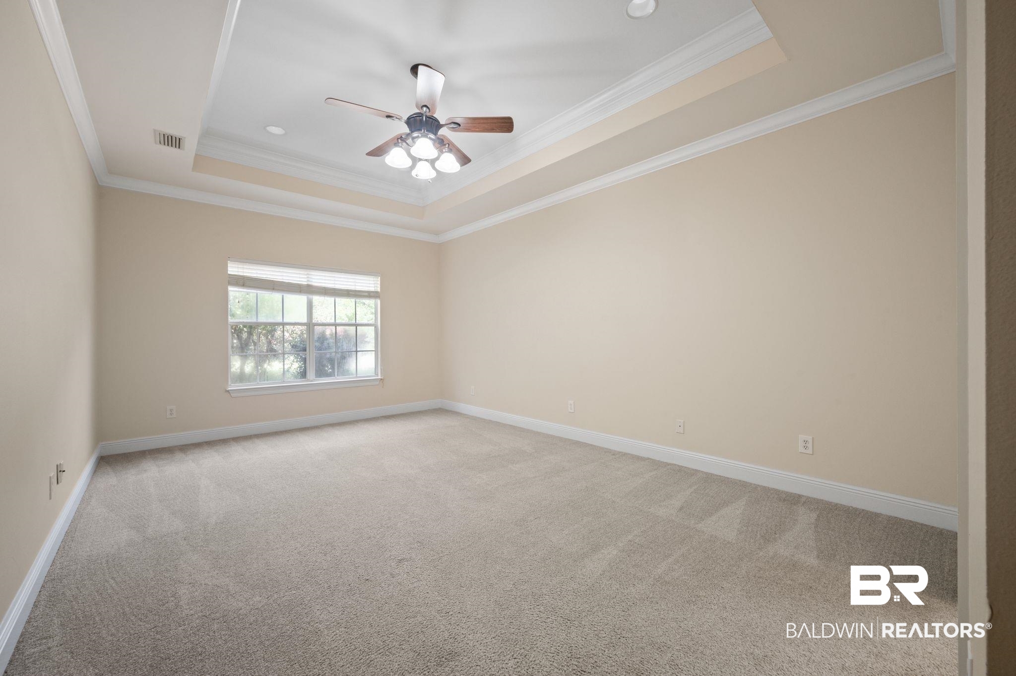 2041 Ridgeline Drive Mobile, AL 36695 - Photo 22 of 43 Carpeted spare room featuring ceiling fan, crown molding, and a tray ceiling