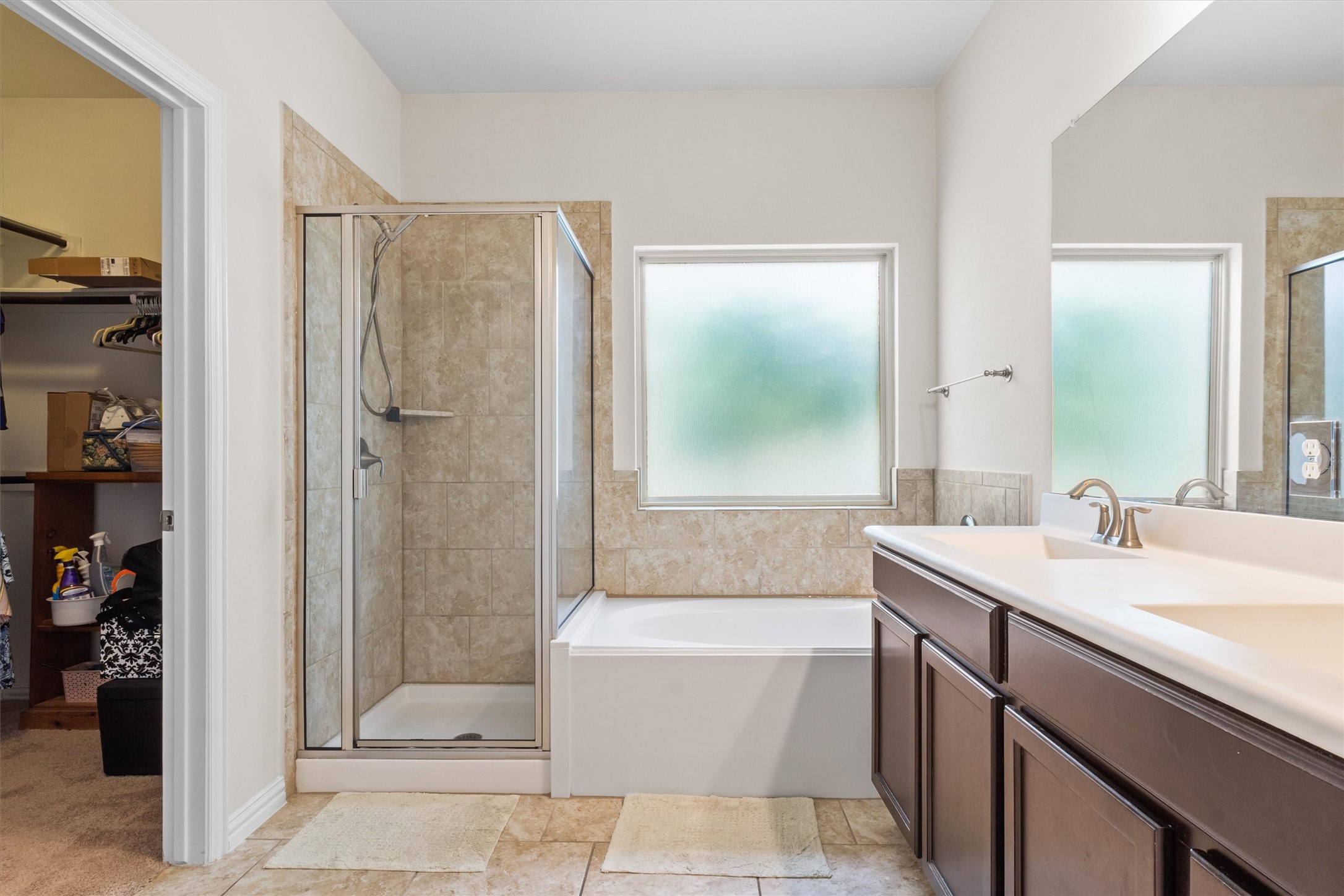 10413 Crescendo Lane Austin, TX 78747 - Photo 15 of 32 A well-appointed bath features a walk-in shower, soaking tub, and vanity.