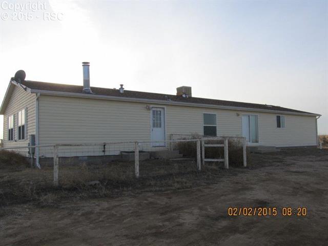 21376 County Road South, Unit 2 Rush, CO 80833 - Photo 3 of 17 Rear of property with white posts.
