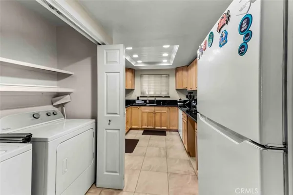 a kitchen with a refrigerator and cabinets