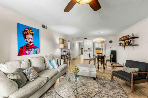 a living room with furniture and kitchen view