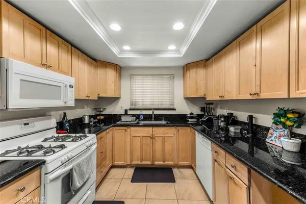 a kitchen with a sink a stove and cabinets