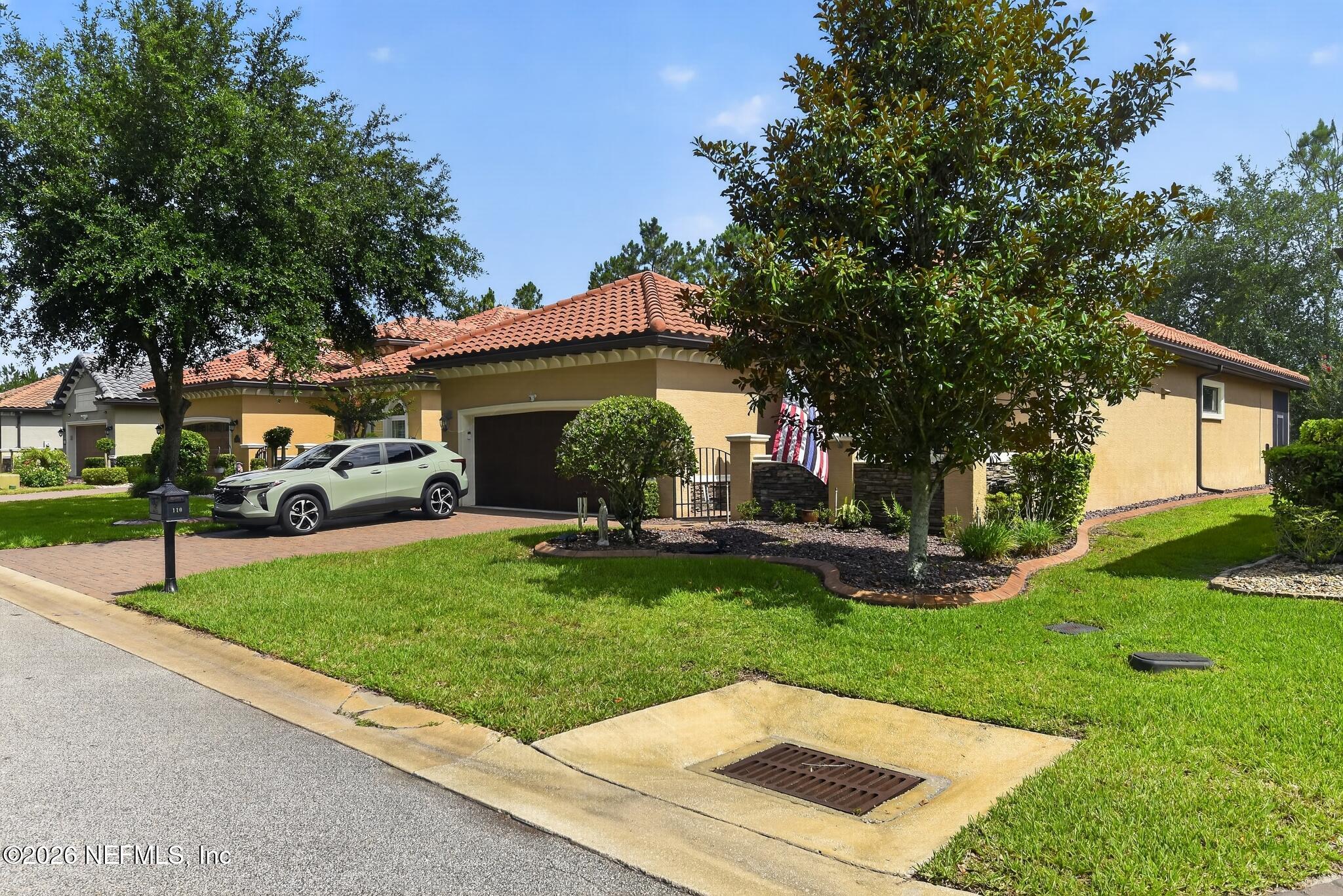 110 Vía Roma Ormond Beach, FL 32174 - Photo 6 of 43 a front view of a house with garden