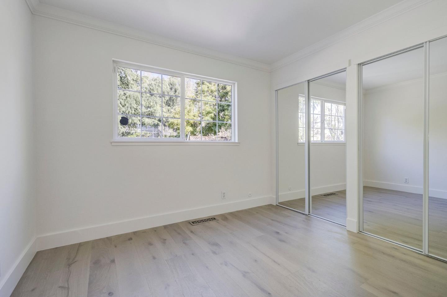 271 Spinnaker Street Foster City, CA 94404 - Photo 14 of 28 an empty room with wooden floor and windows