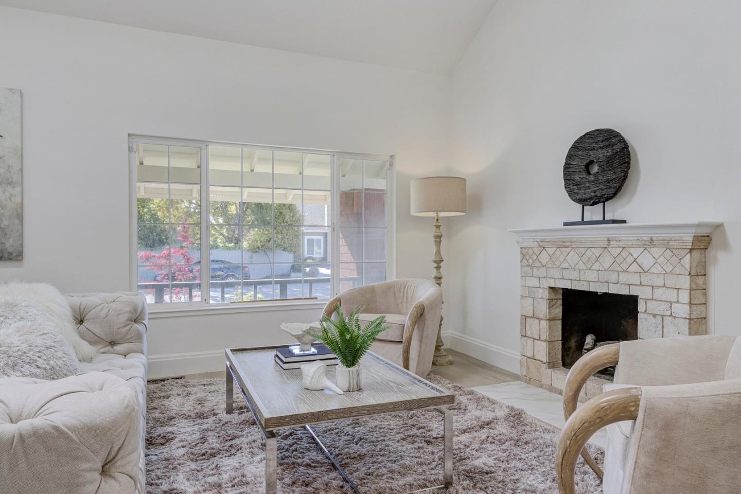 271 Spinnaker Street Foster City, CA 94404 - Photo 7 of 28 a living room with furniture a fireplace and a large window