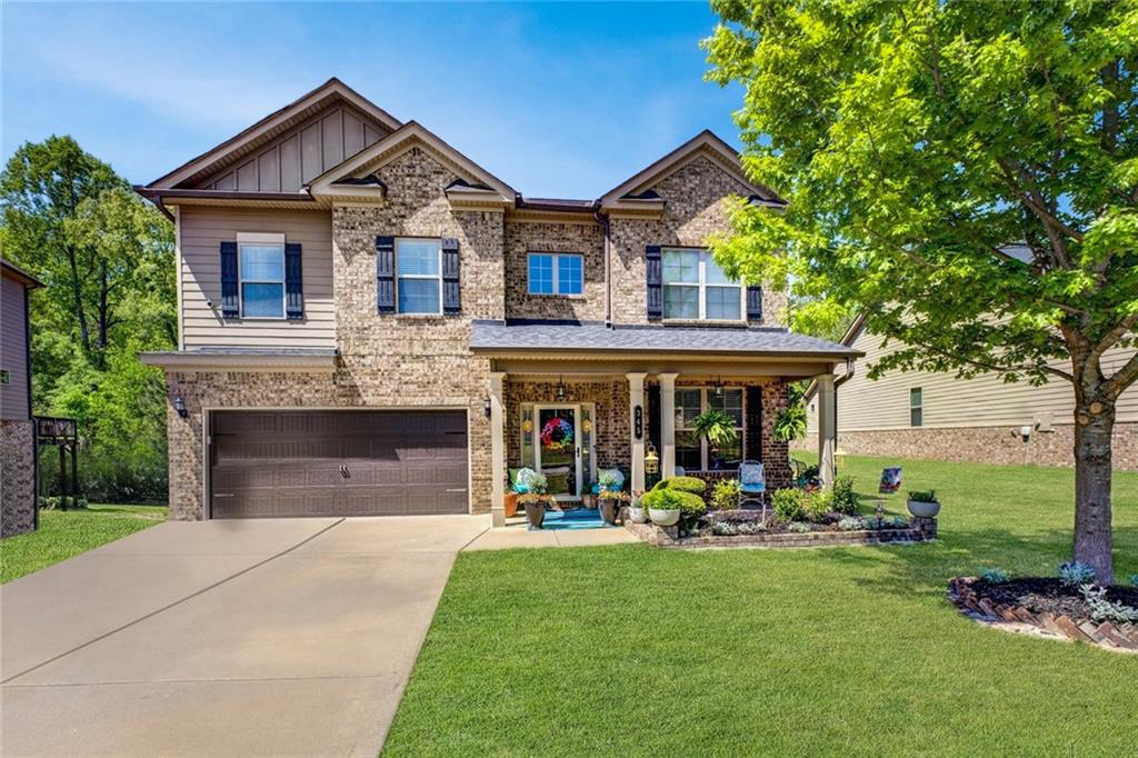 a front view of a house with a yard and fountain