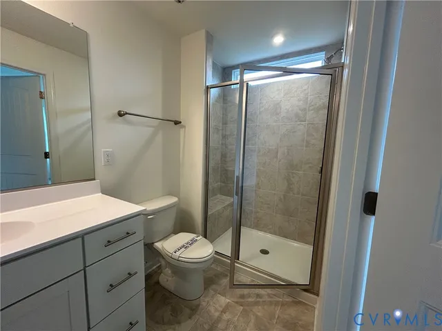 a bathroom with a shower a toilet and sink