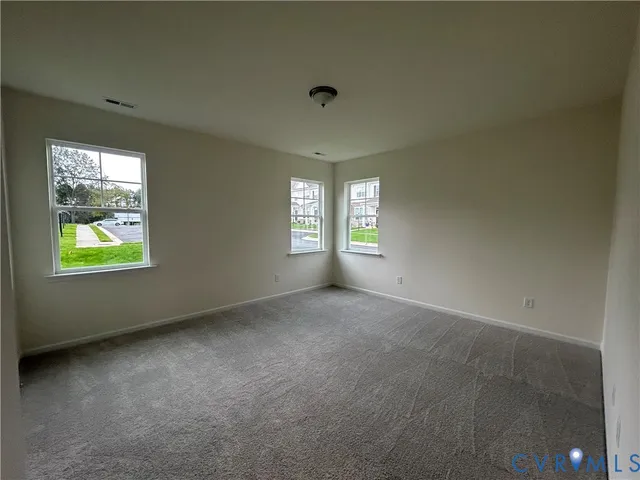 an empty room with windows and closet