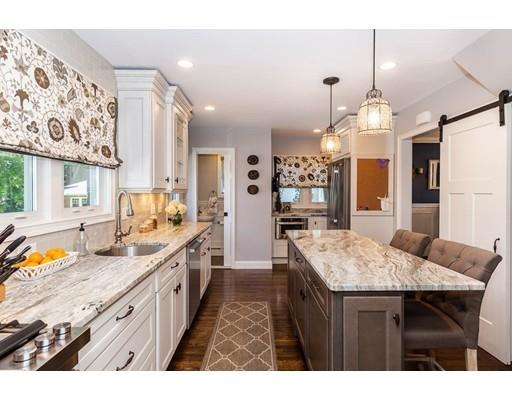 72 Badger Road Medford, MA 02155 - Photo 13 of 42 a kitchen with granite countertop kitchen island stainless steel appliances a sink stove and refrigerator