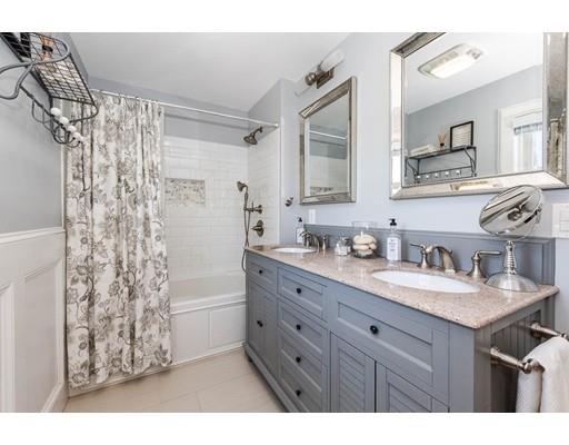 72 Badger Road Medford, MA 02155 - Photo 25 of 42 a bathroom with a granite countertop sink a mirror a vanity and a shower