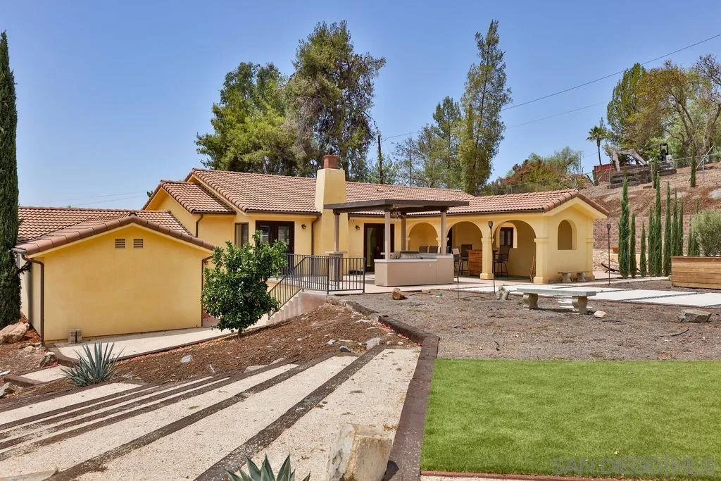 2038 Valley Rim Road El Cajon, CA 92019 - Photo 27 of 37 a view of a white house with a yard and sitting area