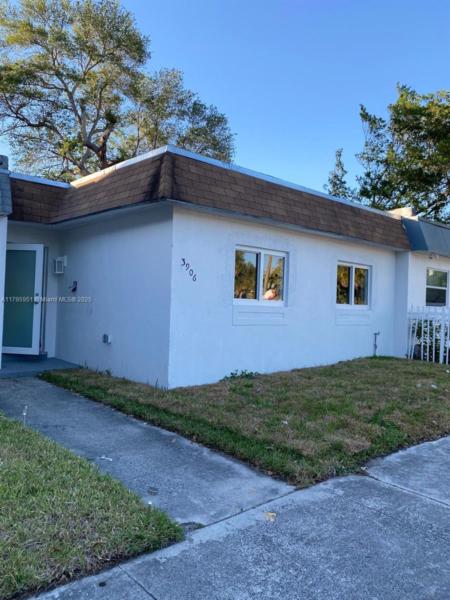 3906 Northwest 207 St Road, Unit 3906 Miami Gardens, FL 33055 - Photo 1 of 19 a backyard of a house with lots of green space