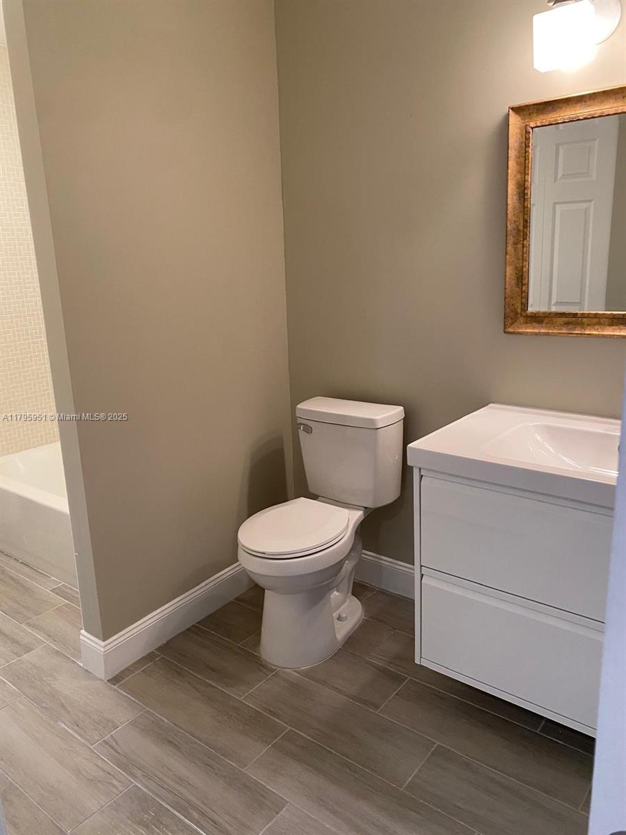 3906 Northwest 207 St Road, Unit 3906 Miami Gardens, FL 33055 - Photo 17 of 19 a white toilet sitting next to a bathroom sink