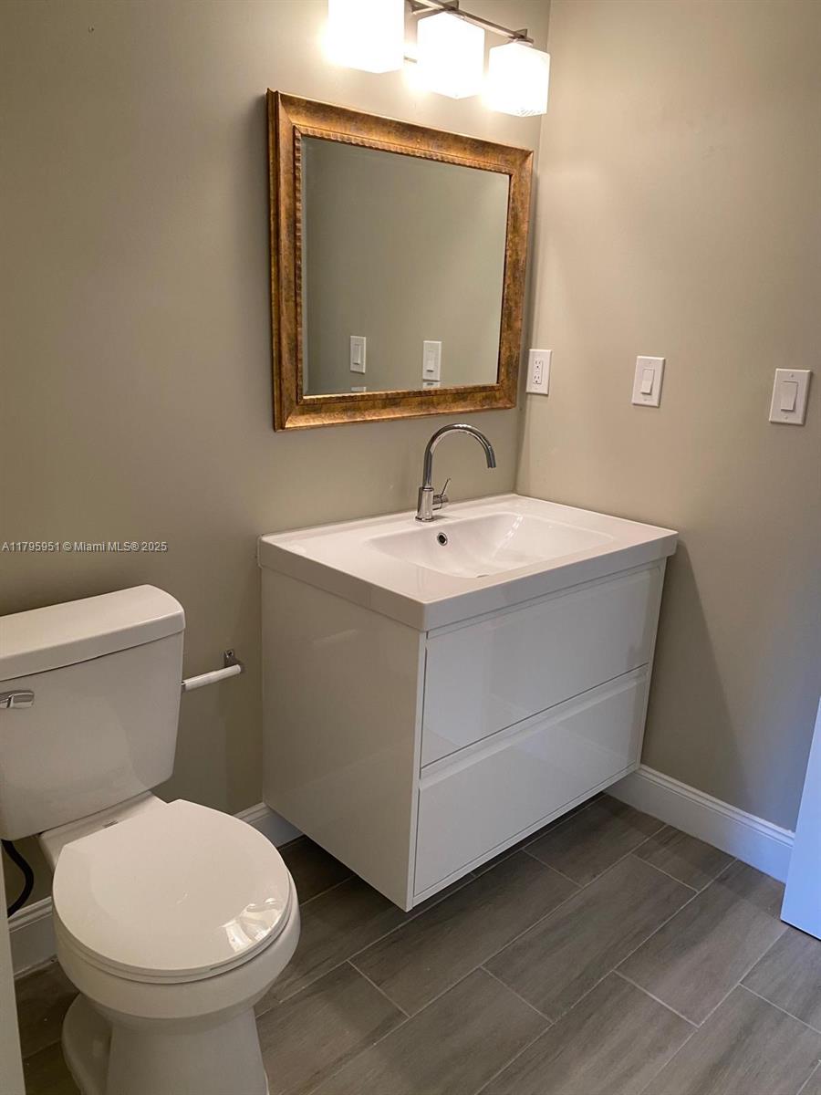 3906 Northwest 207 St Road, Unit 3906 Miami Gardens, FL 33055 - Photo 18 of 19 a bathroom with a toilet sink and mirror