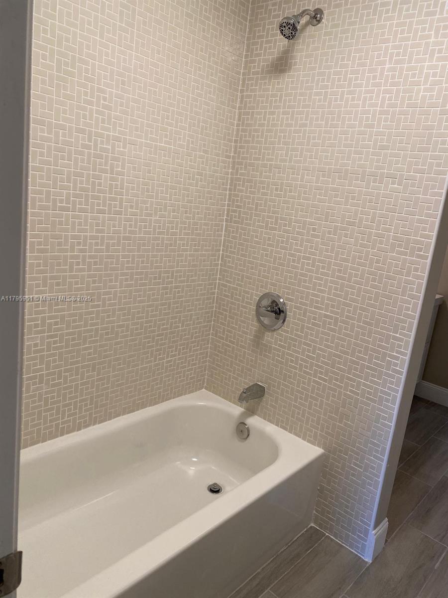 3906 Northwest 207 St Road, Unit 3906 Miami Gardens, FL 33055 - Photo 19 of 19 a bath tub sitting next to a white sink