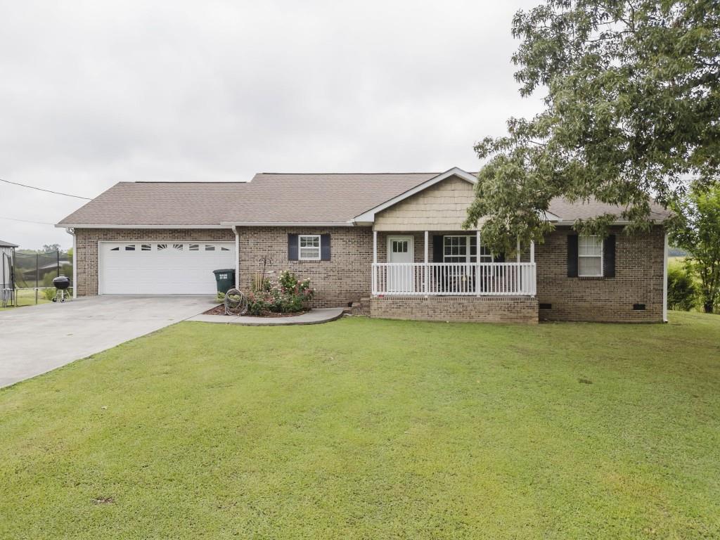 336 Evergreen Road Northeast Resaca, GA 30735 - Photo 1 of 1 a front view of a house with a garden and yard