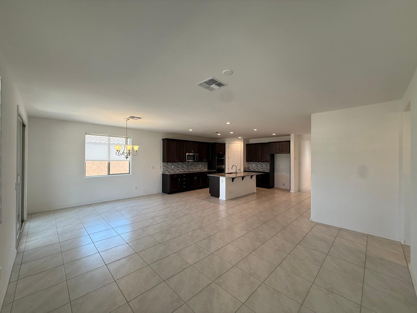 15744 West Jefferson Street Goodyear, AZ 85338 - Photo 15 of 26 a view of empty room with kitchen and window