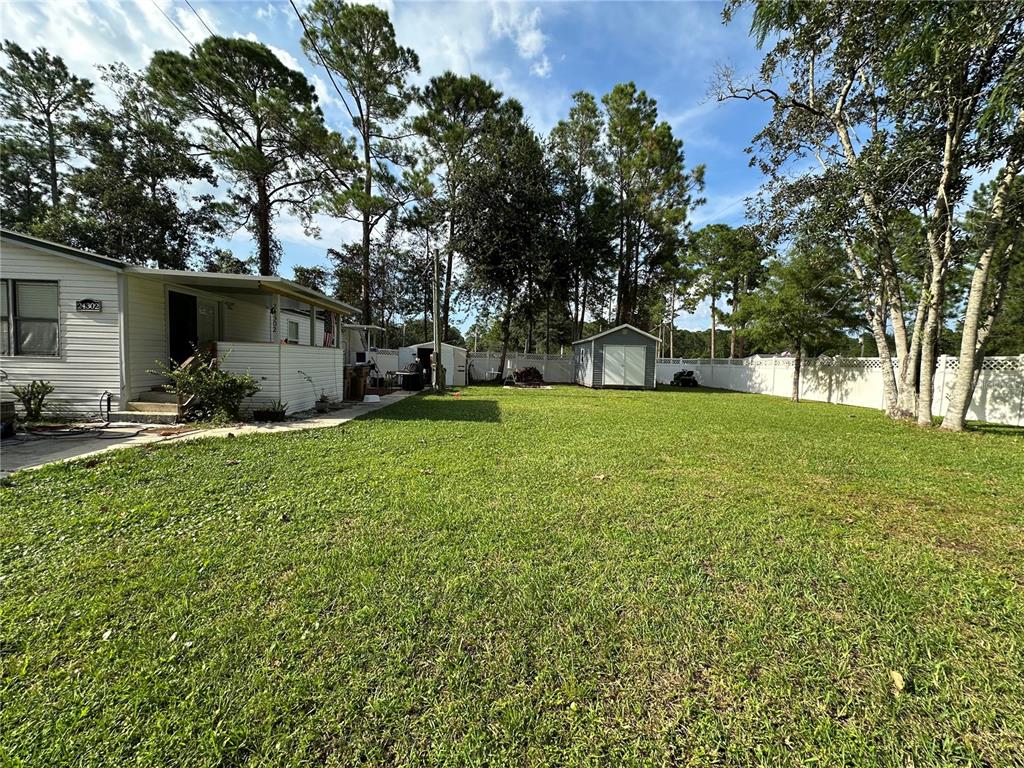 24302 Maxwell Street Astor, FL 32102 - Photo 2 of 11 a view of a backyard with a garden