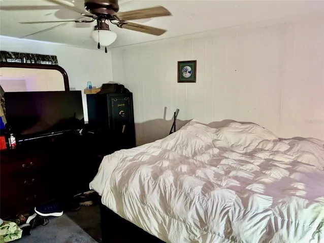 a bedroom with a bed and a flat tv screen
