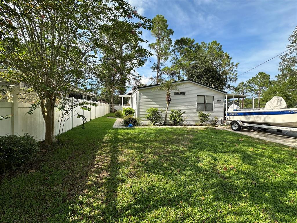 24302 Maxwell Street Astor, FL 32102 - Photo 9 of 11 a front view of house with garden