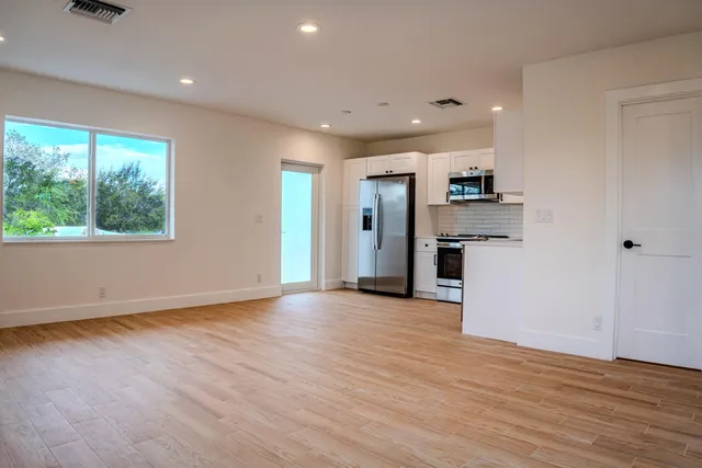 a view of kitchen with stainless steel appliances refrigerator sink and microwave