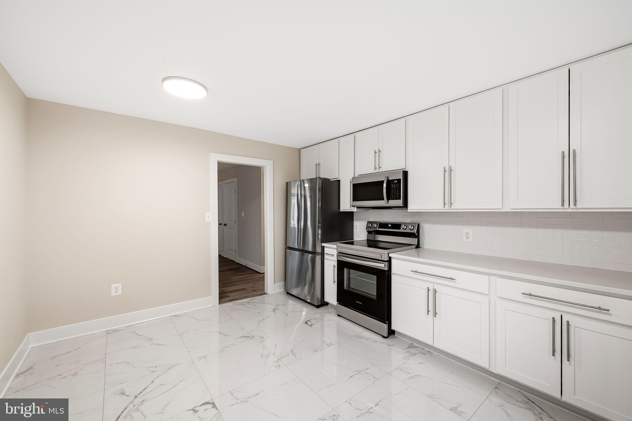 113 Edgewood Road Towson, MD 21286 - Photo 12 of 48 a kitchen with stainless steel appliances granite countertop a refrigerator and a sink