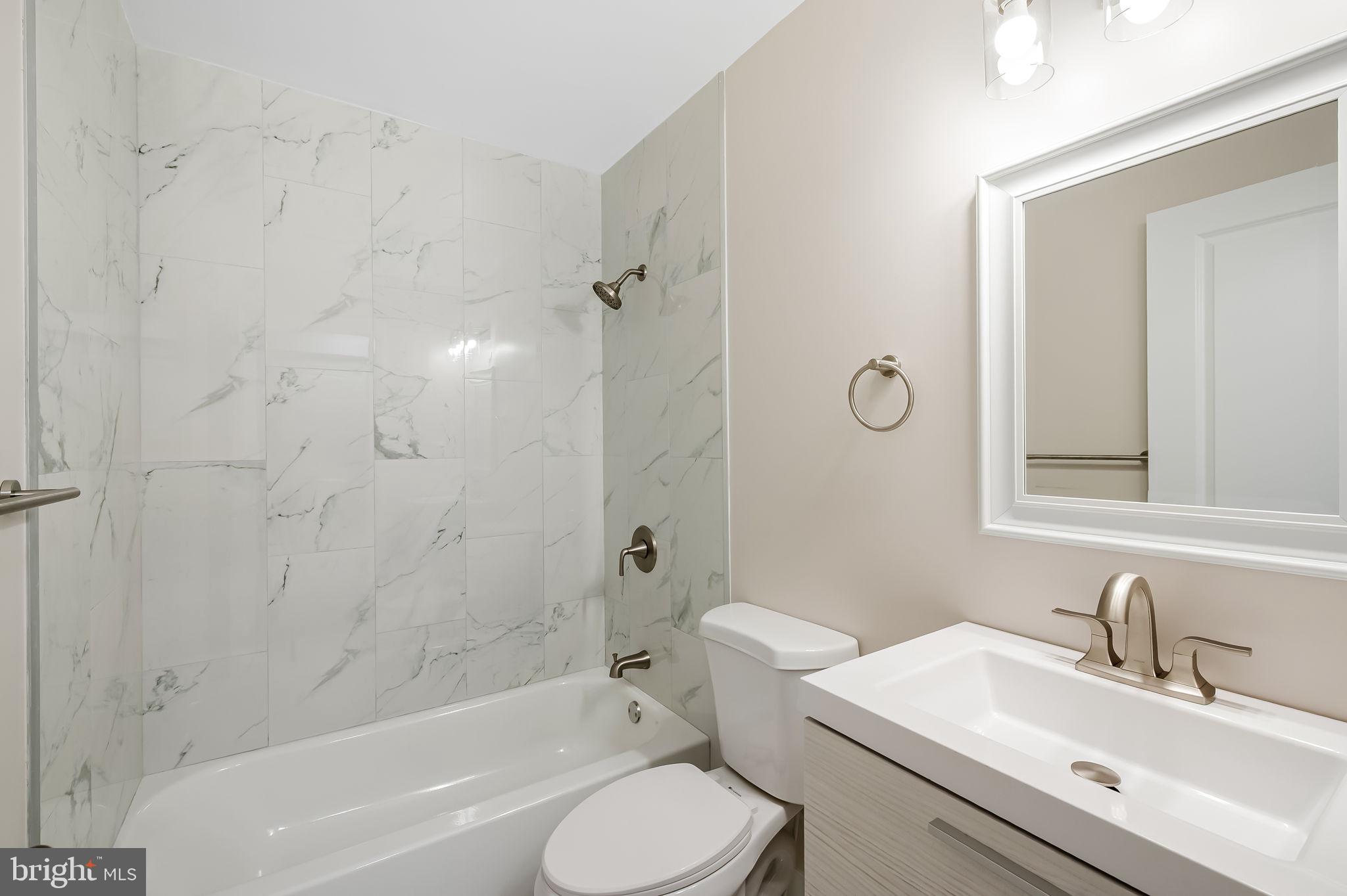 113 Edgewood Road Towson, MD 21286 - Photo 15 of 48 a bathroom with a sink toilet a bathtub and shower