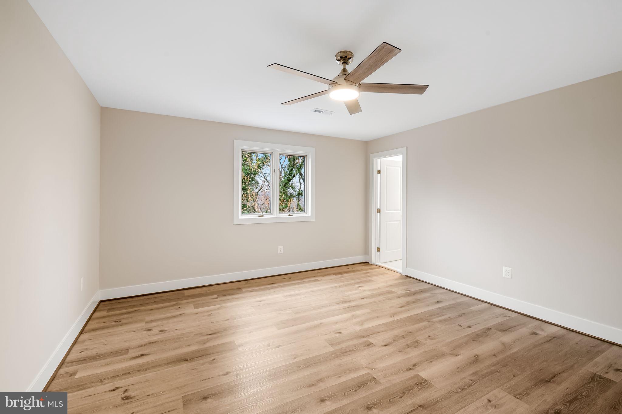 113 Edgewood Road Towson, MD 21286 - Photo 18 of 48 an empty room with wooden floor window and ceiling fan