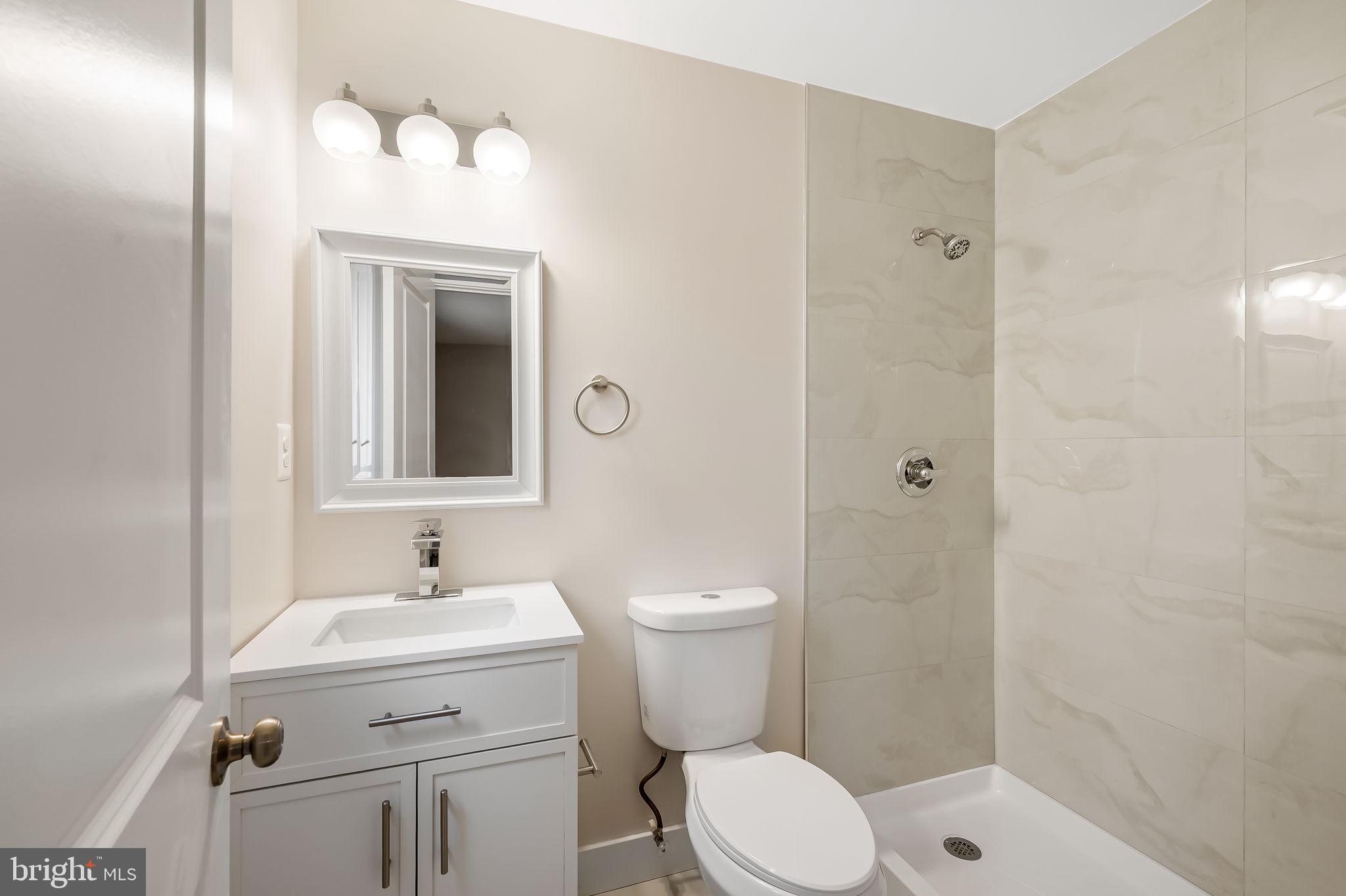 113 Edgewood Road Towson, MD 21286 - Photo 19 of 48 a bathroom with a sink a toilet and shower