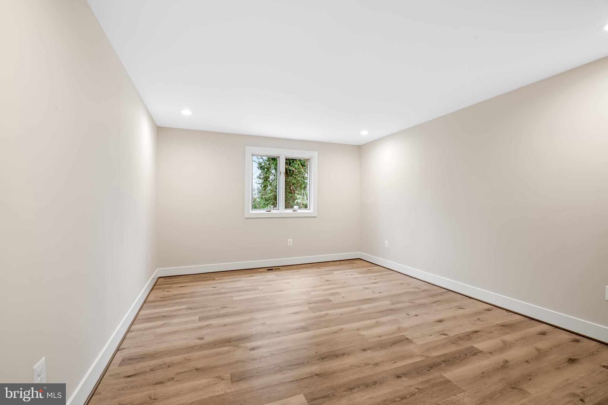 113 Edgewood Road Towson, MD 21286 - Photo 29 of 48 an empty room with wooden floor and windows