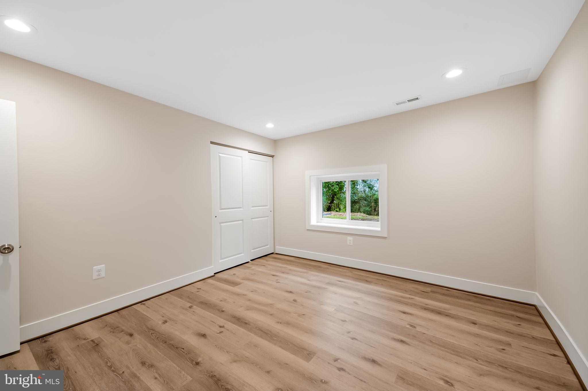 113 Edgewood Road Towson, MD 21286 - Photo 41 of 48 an empty room with wooden floor and windows