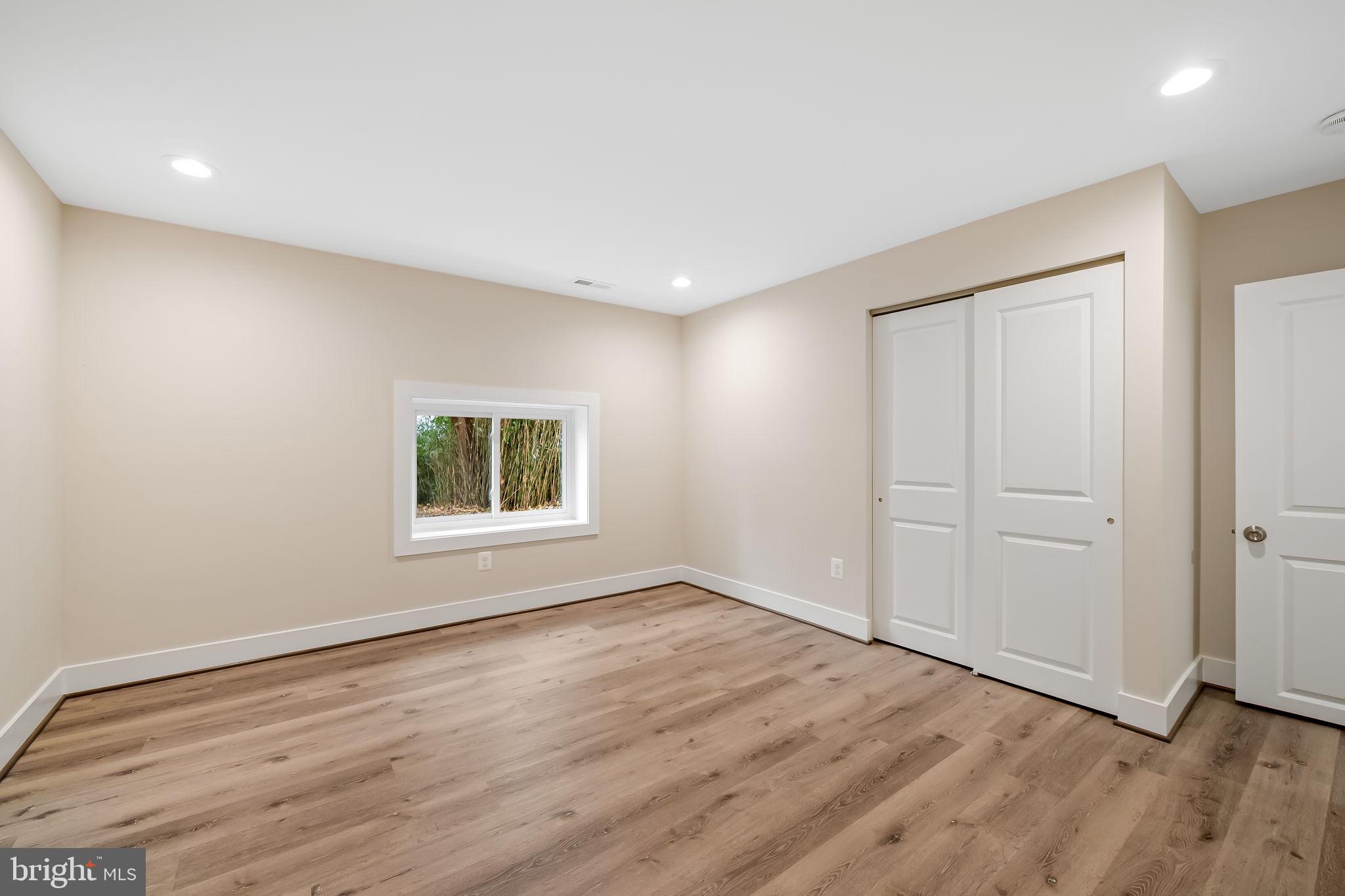 113 Edgewood Road Towson, MD 21286 - Photo 42 of 48 an empty room with wooden floor and windows