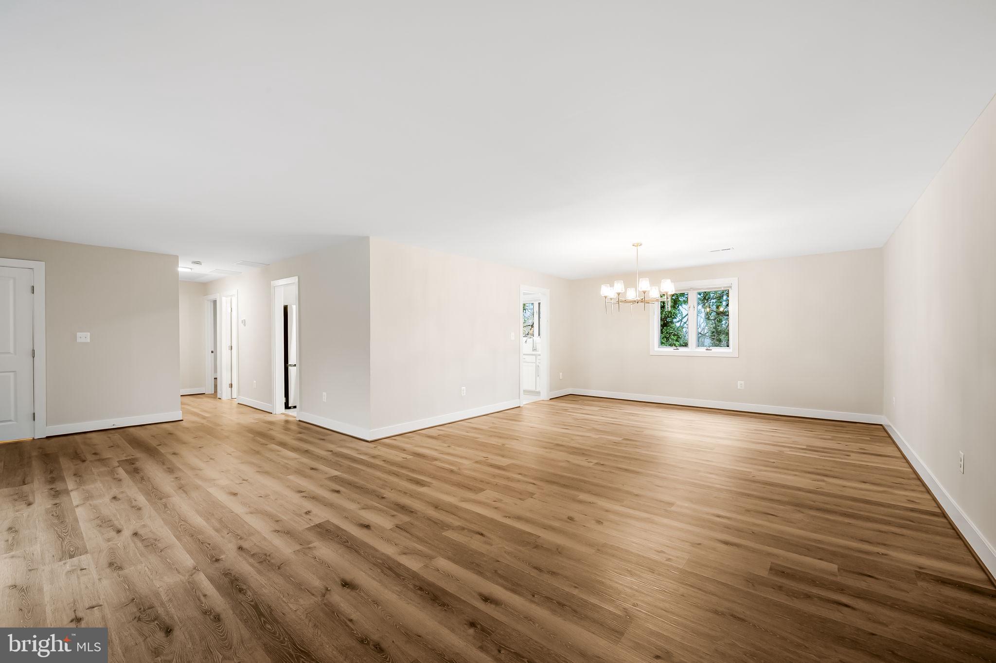 113 Edgewood Road Towson, MD 21286 - Photo 7 of 48 an empty room with wooden floor and windows